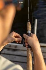 Fototapeta premium Close up of a person reeling in a fishing line