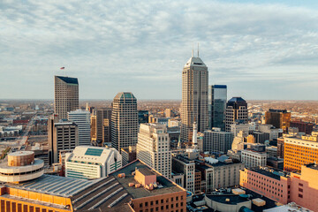 Fototapeta premium Elevated view across a dense downtown skyline in warm light.