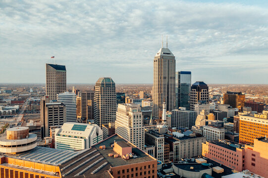 Elevated view across a dense downtown skyline in warm light.
