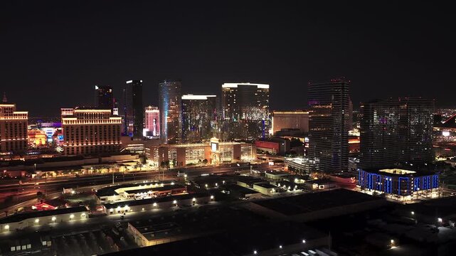A wide aerial view of the Las Vegas strip at night featuring illuminated luxury hotels, casinos, and city traffic. Perfect for travel, tourism, and urban lifestyle content.