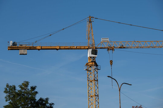 Tower crane against blue sky at construction site