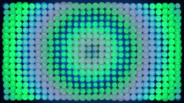 Abstract circular light pattern flickering with green and blue tones in LED display.