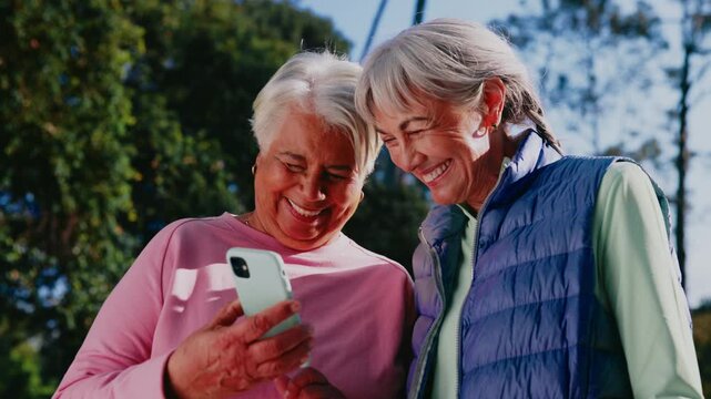 Fitness, phone and laugh with old women in park for runner route, miles tracking and health. Wellness app, training guide and smile with senior friends outdoor for support, joke and exercise progress