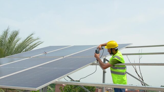 Technician installing solar panels on a rooftop in Farrukhabad Uttar