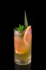 Fototapeta premium Refreshing grapefruit cocktail with mint and ice on black background