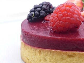 Close-up of red berry tartlet topped with fresh raspberry and blackberry © Dimitri