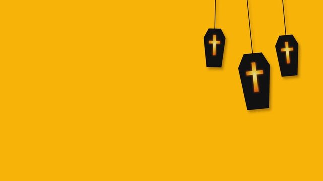 Three hanging coffin ornaments on a yellow background