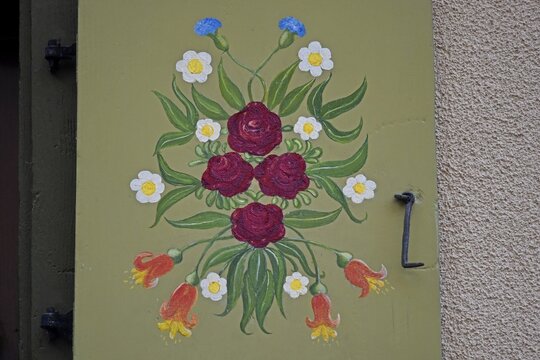 Typical Alsatian rural house wooden window shutter with Bauermalerei folk art painting in Bergheim, Alsace France.