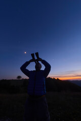 Fototapeta premium Amateur astronomer observing stars, planets and other celestial objects.