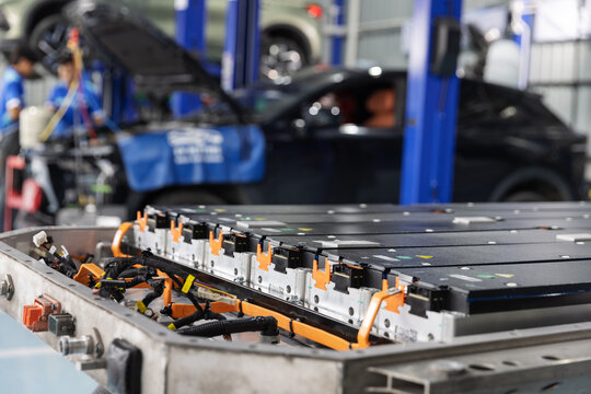  Open Electric Vehicle Battery Pack in an Automotive Repair Workshop