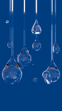 Transparent liquid drops with bubbles suspended against blue