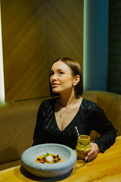 Beautiful young woman sitting at a table in a cafe