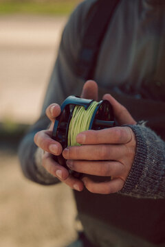 Close view of an angler holding a loaded fly reel.