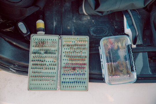 Organized fly fishing tackle is arranged in the back of a vehicle.