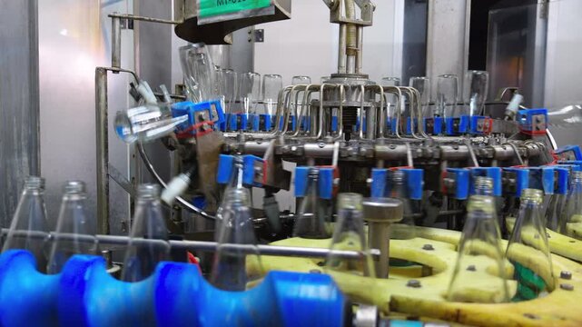 Commercial production line automation showcasing efficient beverage packaging workflow industrial equipment manufacturing empty bottles quality control standards supply chain logistics.