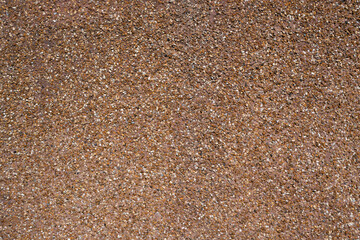 Brown exposed aggregate concrete wall with pebble dash texture © Jane Allan