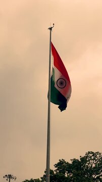 Indian national flag waving proudly in strong wind against overcast cloudy sky footage.