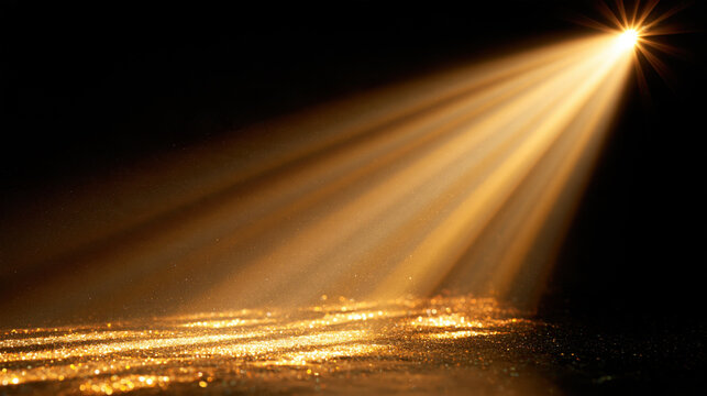 Golden spotlight beam on black background with shimmering glitter surface and dramatic volumetric light overlay