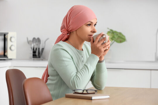 Cancer recovery and wellness, woman with headscarf drinking tea at home for mental health support and healing journey after chemotherapy treatment