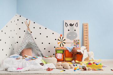 Childhood development and play, cozy nursery room with teepee tent and educational toys for creative learning and early education in a modern home © Pixel-Shot