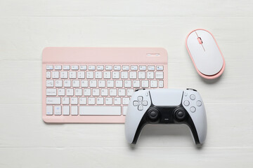 Gaming and remote work setup, pink wireless keyboard with computer mouse and game controller on white wooden desk for digital lifestyle and leisure © Pixel-Shot