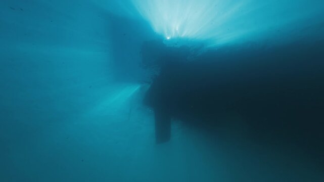 Sailing boat as seen from the bottom of the sea, underwater view of the rudder and keel of a sailing boat