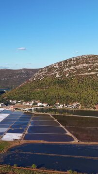 Croatia, Ston, aerial footage of salt pans, salt flats, and surrounding mountains