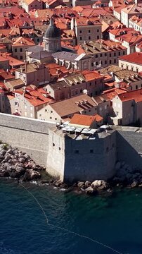 Dubrovnik, Croatia, aerial view of the historic old town, ancient fortress walls and red tile roofs by the sea