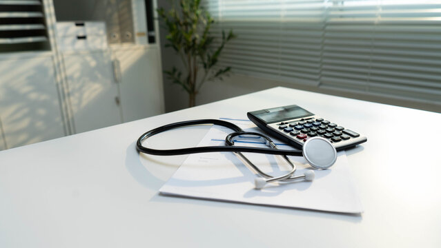 Health insurance concept. Stethoscope and calculator show healthcare costs on medical documents. health insurance, medical expenses, budgeting, financial planning, billing and patient care.