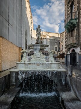 The historic Fontana dell'Amenano marble fountain and cascading water channel in Piazza del Duomo, Catania, Sicily, Italy.
