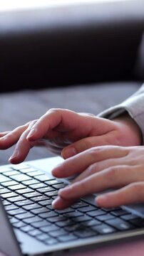 Fingers Press Laptop Keys While Working Indoors. Busy Worker Operates Portable Computer With Careful Precision, Typing Essential Information During Productive Quiet Session At Modern Home.