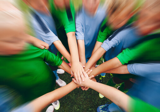 Dynamic Top-Down View of Youth Soccer Team Hands Together in Circle - Children Football Unity, Teamwork, and Motivation Concept