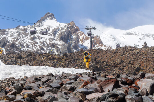 Sky Waka gondolas travel across the volcanic landscape of Mount Ruapehu at Whakapapa Ski Field, surrounded by rugged rock formations and snow-covered alpine peaks in New Zealand