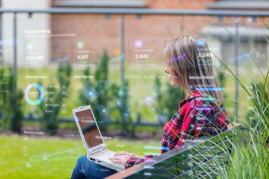 woman with laptop computer and application dashboards