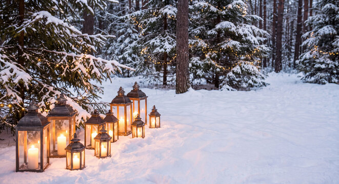 Illuminated lanterns with glowing candles on snow in a winter pine forest landscape at dusk