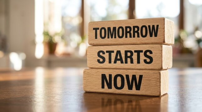 Wooden blocks spell out the phrase tomorrow starts now with blurred background
