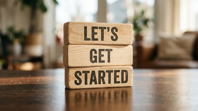 Wooden blocks spell out lets get started in a bright interior setting