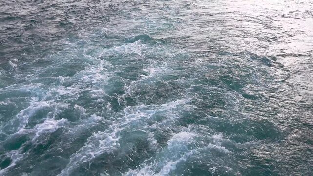 Close up view of the wake, back waves of a sailing boat.