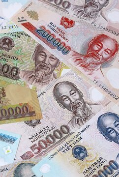 Big amount of Vietnamese dong money banknotes. Vietnam cash bills of VND currency close up