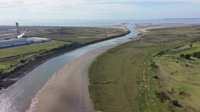 Winding Mouth of River Neath at Low Tide with Mix of Natural Landscape and Industrial Factory.