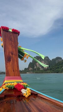 slow motion sailing on traditional longtail boat to raily beach in krabi