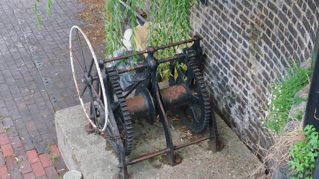 Victorian-era canal winch with gears and wheel, historically used for hauling boats or operating lock gates