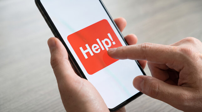 Hand holds a smartphone displaying a red Help button on screen for emergency assistance.