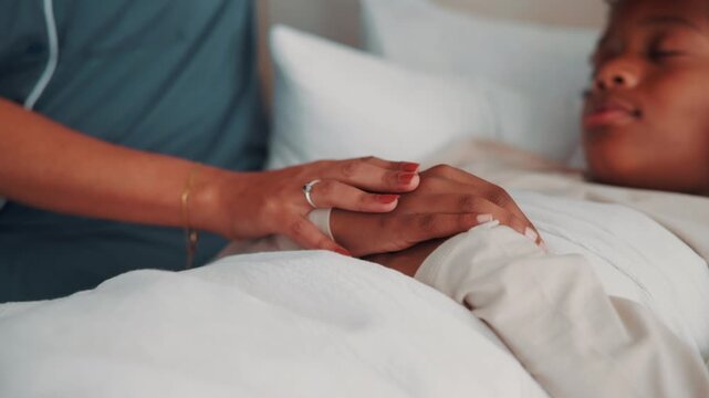 Family, holding hands and parent with sick child in bedroom, health check and concern for son on bed. Childcare, home and person with empathy for kid, comfort and support for boy with flu symptoms