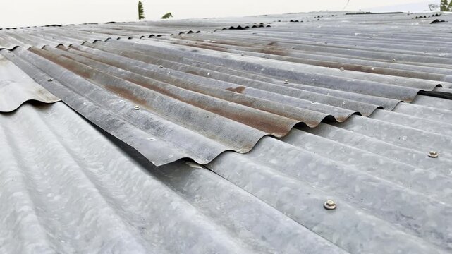 Perspective view of old rusty corrugated metal roof under daylight