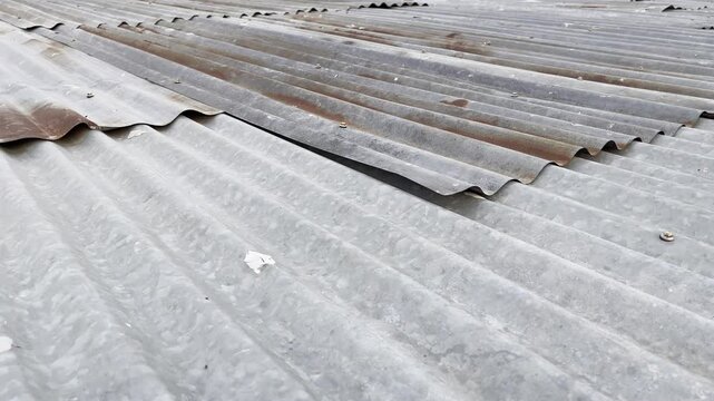 Weathered zinc roofing sheets with heavy rust and corrosion patterns