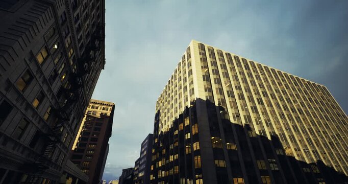 Historic structures contrast with contemporary glass constructions, Traditional brick edifices alongside modern glass skyscrapers at dusk create visual harmony
