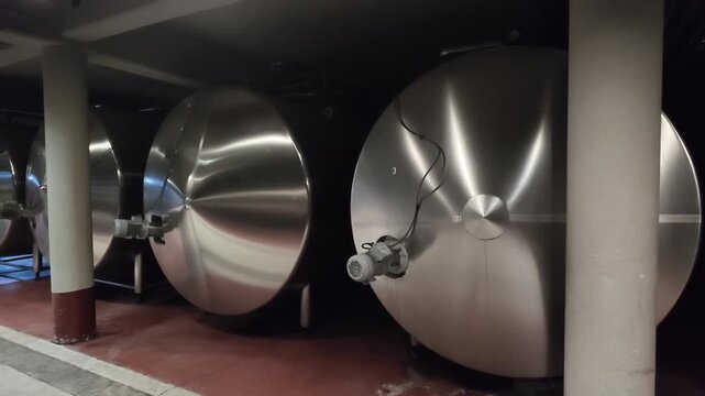 Horizontal stainless steel wine tanks feature polished cylindrical vessels, access fittings, valves and temperature-control connections for sparkling wine production, fermentation and storage, pan