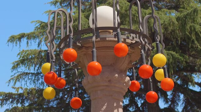 Close-up of whimsical outdoor lamp post with colorful globes at Villa Grock, Imperia