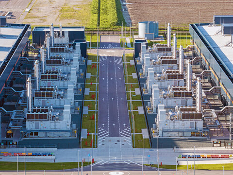 Aerial view of Microsoft datacenter featuring rows of industrial cooling units and technical infrastructure situated in a rural landscape Middenmeer, Noord-Holland, Netherlands.